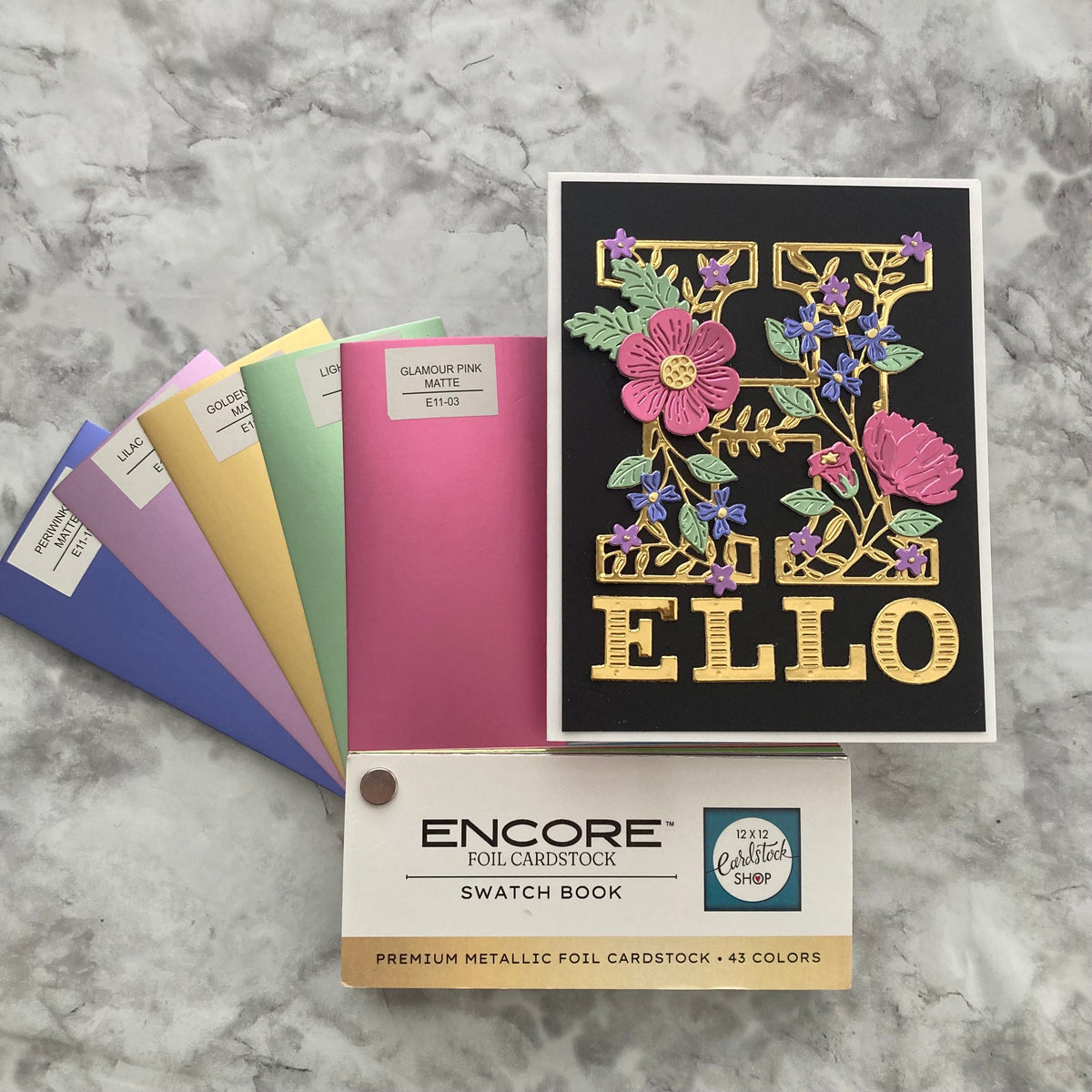 Foil cardstock card with a swatch book with colorful samples 