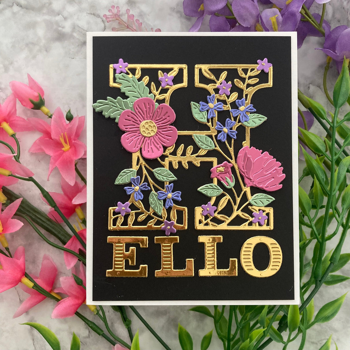 Decorative card with floral and gold lettering on a floral background