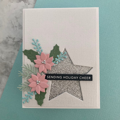 Handmade christmas card with flowers and star design on a textured cardstock.