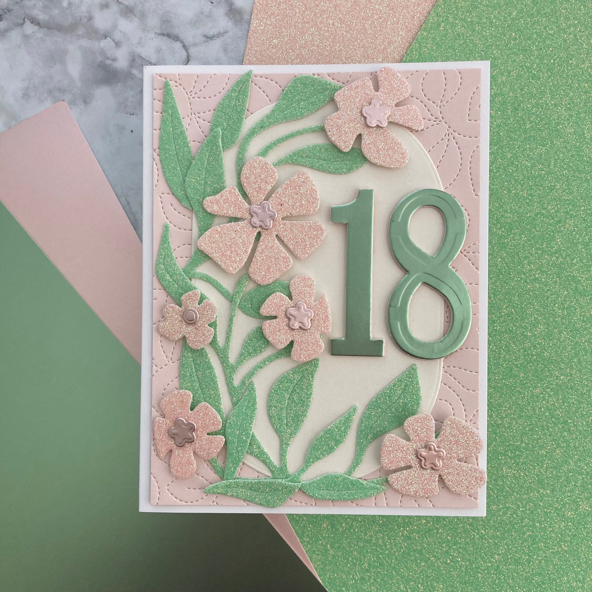 handmade birthday card with floral design and number 18 using glitter and oil cardstock